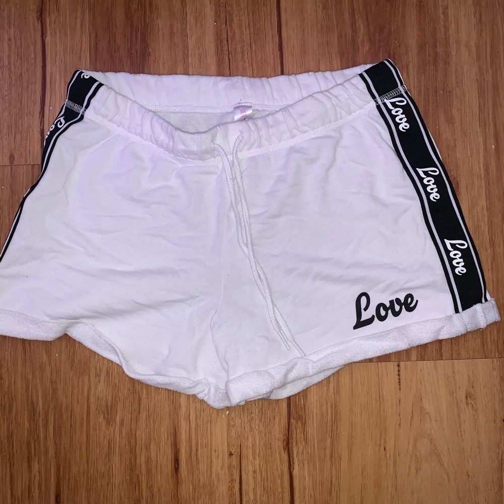 White shorts with the print love